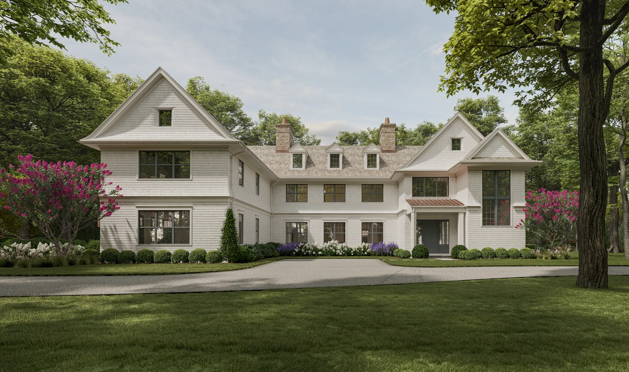 White shingle-style estate set among mature trees