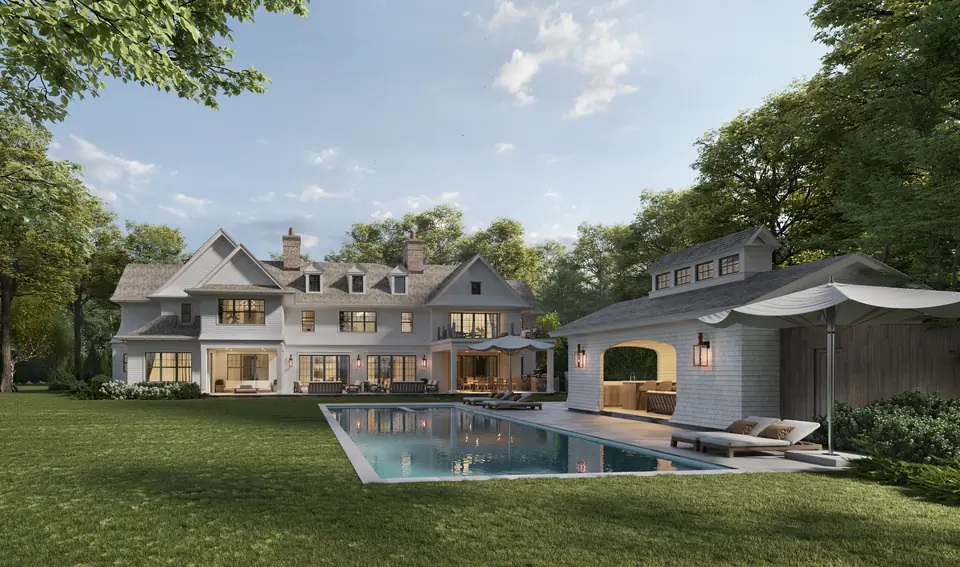 Shingle style house and pool house at dusk